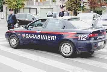 Turisti all’arrivo in un aeroporto. A sinistra un laboratorio di analisi