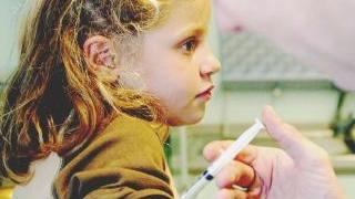 Un medico somministra il vaccino a una bambina