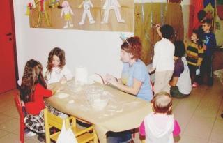 Bimbi e un’operatrice in una scuola materna