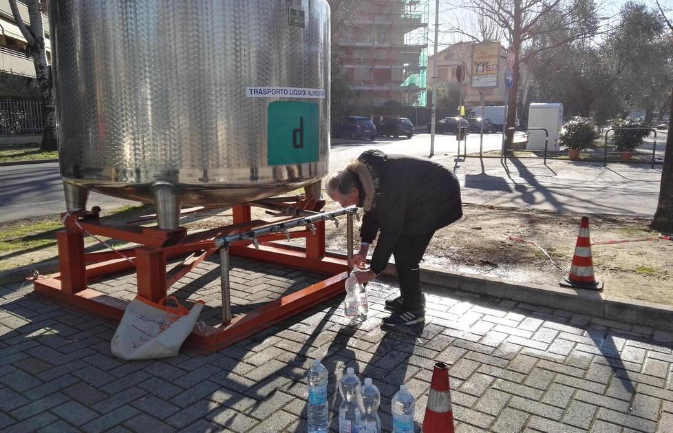 Un residente intento a riempire bottiglie d’acqua dalla botte collocata in via Capponi alla Pietà 