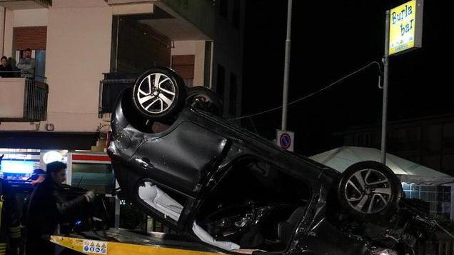 Auto sbanda, va a sbattere su due veicoli e si ribalta