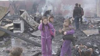 Alcuni bambini nomadi su quel che resta delle baracche