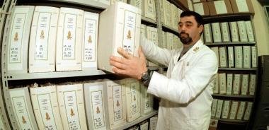 Un agente della Finanza controlla fascicoli in archivio     