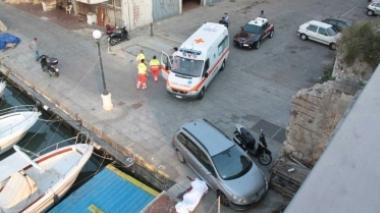 Il corpo senza vita dell’uomo coperto da un lenzuolo accanto a un’auto e l’ambulanza della Svs