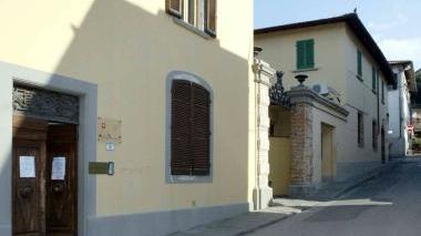 La sede della polizia municipale di Cerreto e più a destra erba alta ai margini di una strada