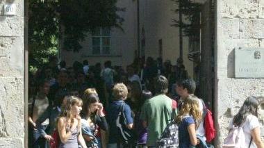 Studenti davanti a una scuola il giorno della prima campanella