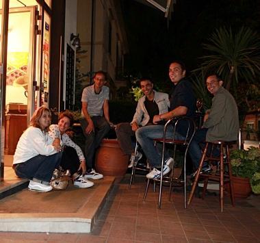 Il ristoratore e consigliere Fipe Aleandro Roncar&agrave; e clienti di un bar fuori dal locale di notte 
