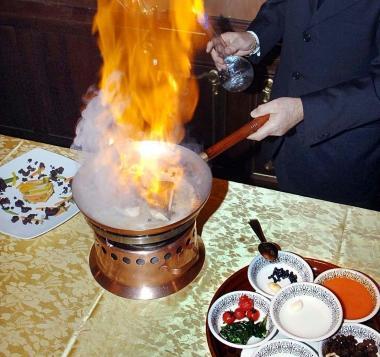 La preparazione di frutta flamb&eacute;e in una immagine di repertorio  