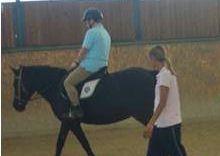 Un bambino a cavallo, seguito dallinsegnante, nel centro A.Po.Di 