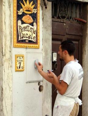 Matteo Andreazzoli mentre piazza deodoranti davanti alla sua panetteria 
