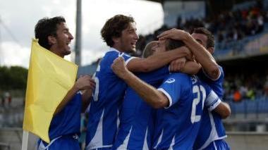 Stovini sommerso dall’abbrccio dei compagni di squadra dopo aver messo a segno il gol decisivo