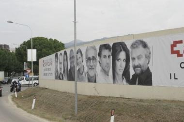 Il poster dei vip famosi che copre il cantiere del Pecci 