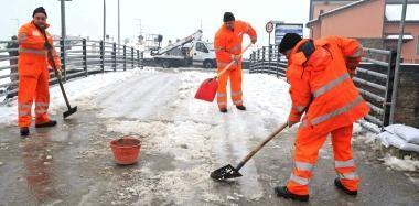 Operai del consorzio Ombrone spalano neve sul ponte di Ferruccia 