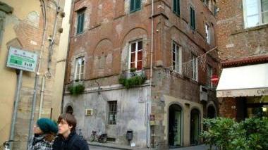 La casa natale di Giacomo Puccini in corte San Lorenzo e, sotto, un allestimento di Tosca, una delle opere più note del Maestro