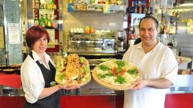 Simona e Andrea mostrano due delle pizze che propongono ai clienti