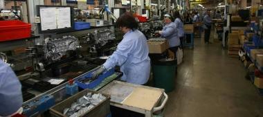 Operai allinterno della Piaggio mentre lavorano alla catena di montaggio 