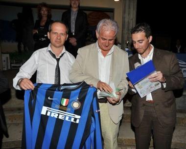 A sinistra il vice direttore dellInter Filucchi (al centro) con la maglia di Milito 