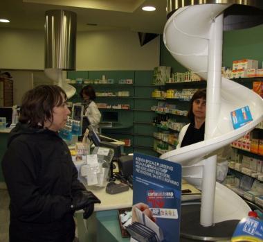 Medico visita una paziente A sinistra una farmacia e, sotto il pagamento del ticket a uno sportello automatico 
