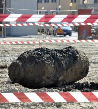 Di lato l’ordigno ritrovato durante gli scavi e gli uomini delle forze dell’ordine e della protezione civile che lo vigilano costantemente: pesa 500 chili ed è lunga quasi 1.30 metri
