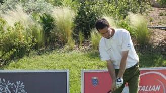 Un giocatore di golf alla partenza del percorso di una buca
