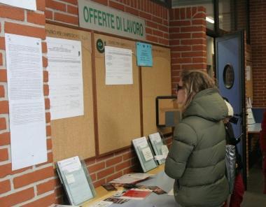 Una ragazza controlla gli annunci di lavoro in un centro per limpiego e sotto Giovanni Occhipinti 