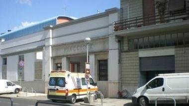 Un’ambulanza davanti all’ingresso della Piaggio; sotto un gruppo di operai