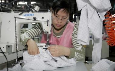 Una lavoratrice cinese alla macchina da cucire 