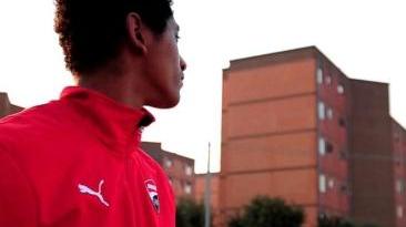 A sinistra uno dei protagonisti del filmato sopra una scena del video dei ragazzi del centro
