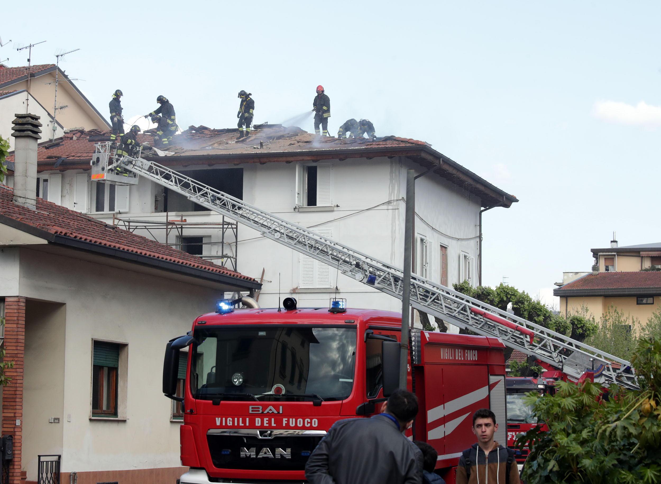 I vigili del fuoco sul tetto della palazzina in fiamme (Foto Nucci)