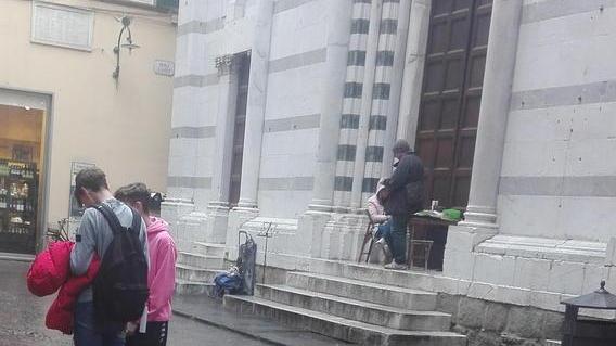 Fanno un picnic sui gradini della chiesa