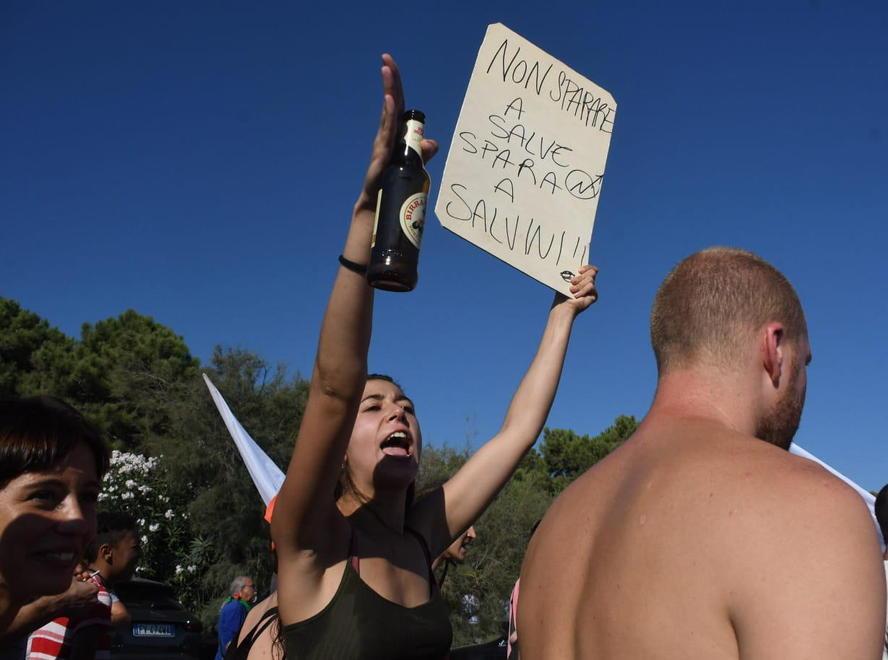 Una ragazza innalza un cartello anti-Lega al corteo di Massa