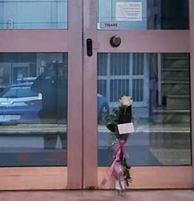 Una rosa davanti all’ingresso della questura