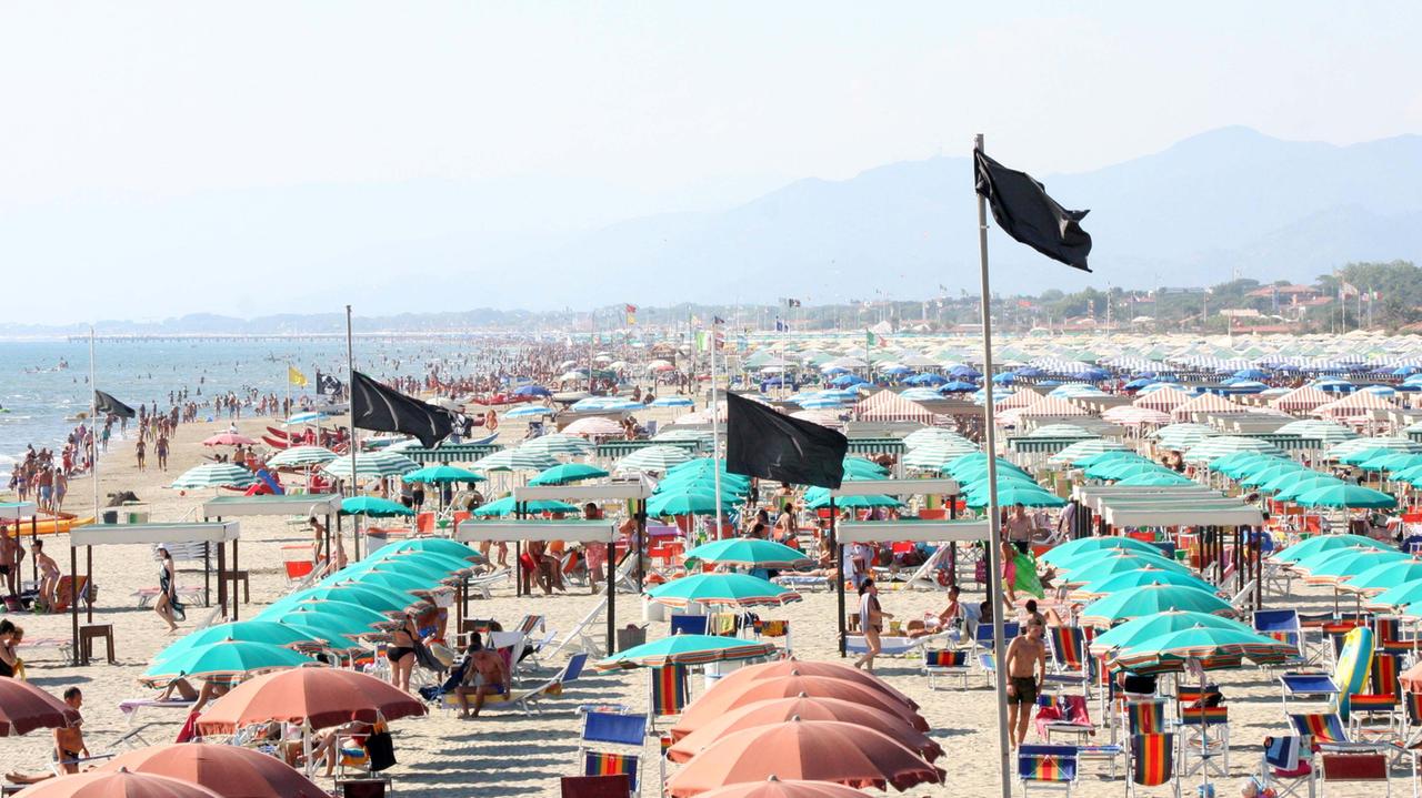 Una vista delle spiagge della Versilia con le bandiere nere del "No aste"