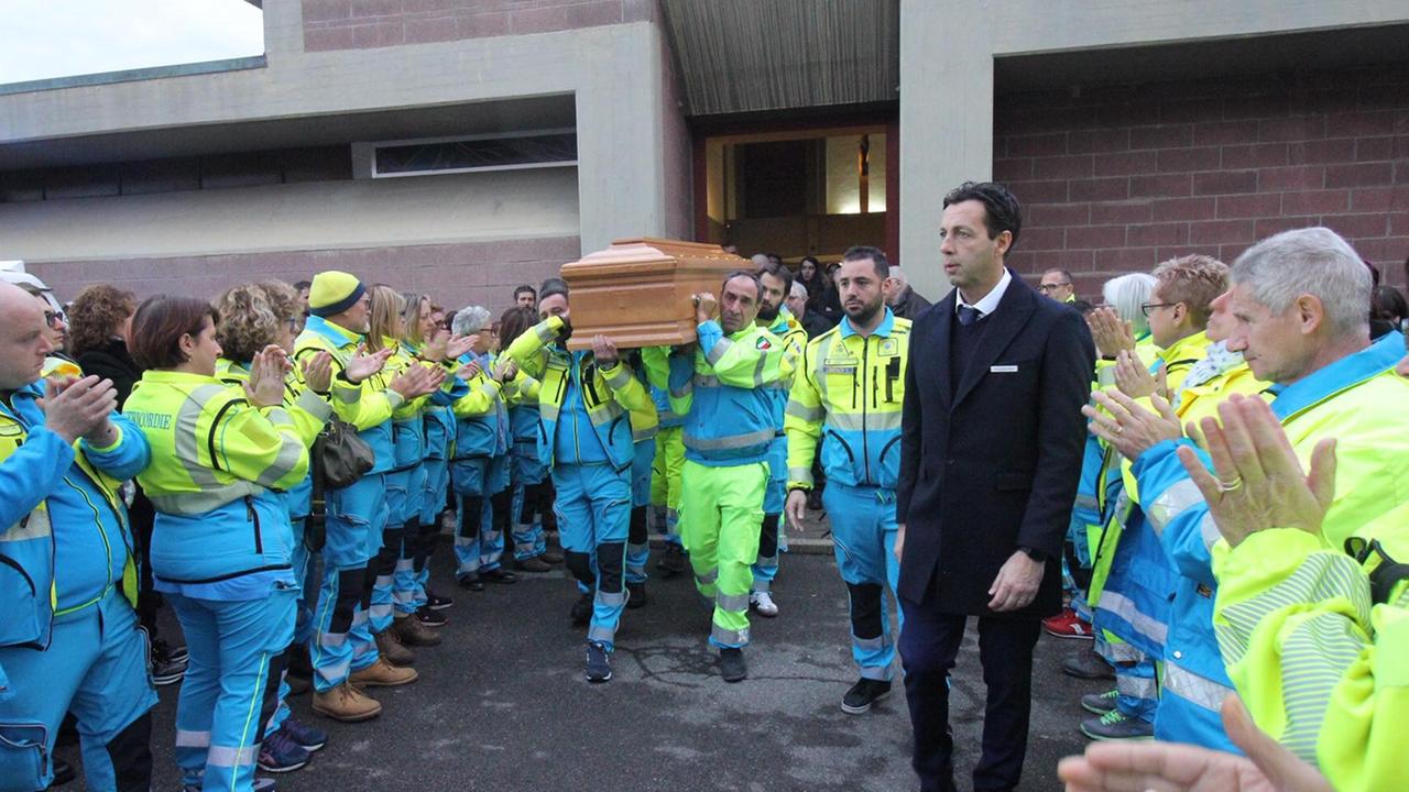 Don Amidei coi volontari della Misericordia mentre escono dalla chiesa portando il feretro