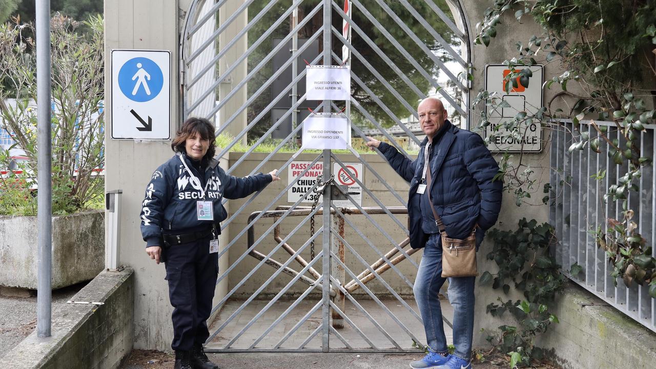 La vigilante dell'ospedale Anna Maria Guarienti e il dipendente Pacini Paolo davanti all'entrata chiusa di via della Meridiana pronti per dare indicazioni agli utenti (foto Marzi)