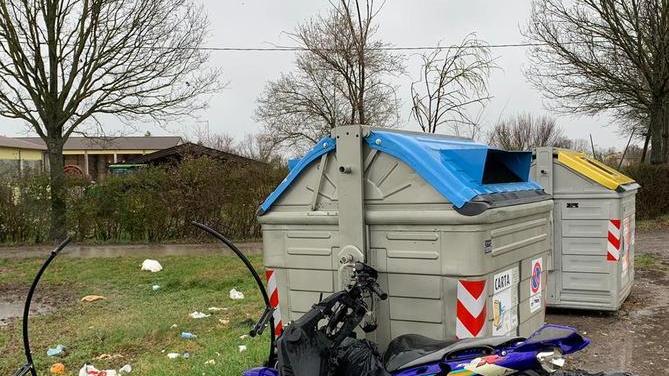 Uno scooter abbandonato accanto ai cassonetti