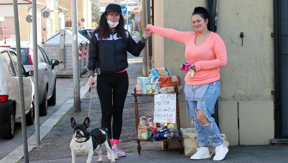 Elena e Maria, le due sorelle romene che hanno allestito un banchetto in via Carducci per aiutare chi ha bisogno (Foto Paolo Nucci)