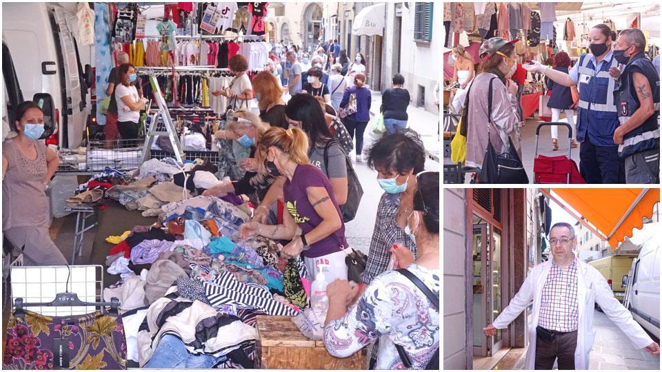 Uno dei banchi particolarmente visitato dai clienti, tutti muniti di mascherina e di guanti di plastica per poter toccare la merce, due volontari danno informazioni a una signora e il titolare di Ottica Turi in piazza Gavinana, Andrea Pierattini che si è lamentato per la presenza troppo vicina alla sua vetrina di uno dei banchi del mercato degli ambulanti
