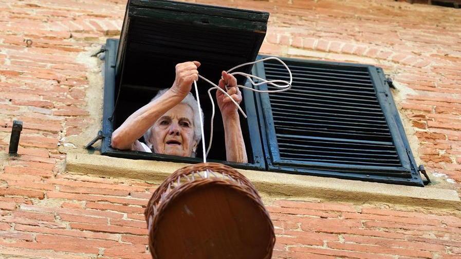 Il cestino, la corda e l’amore di figli e fratello: così Rosa fa la spesa dalla finestra di casa
