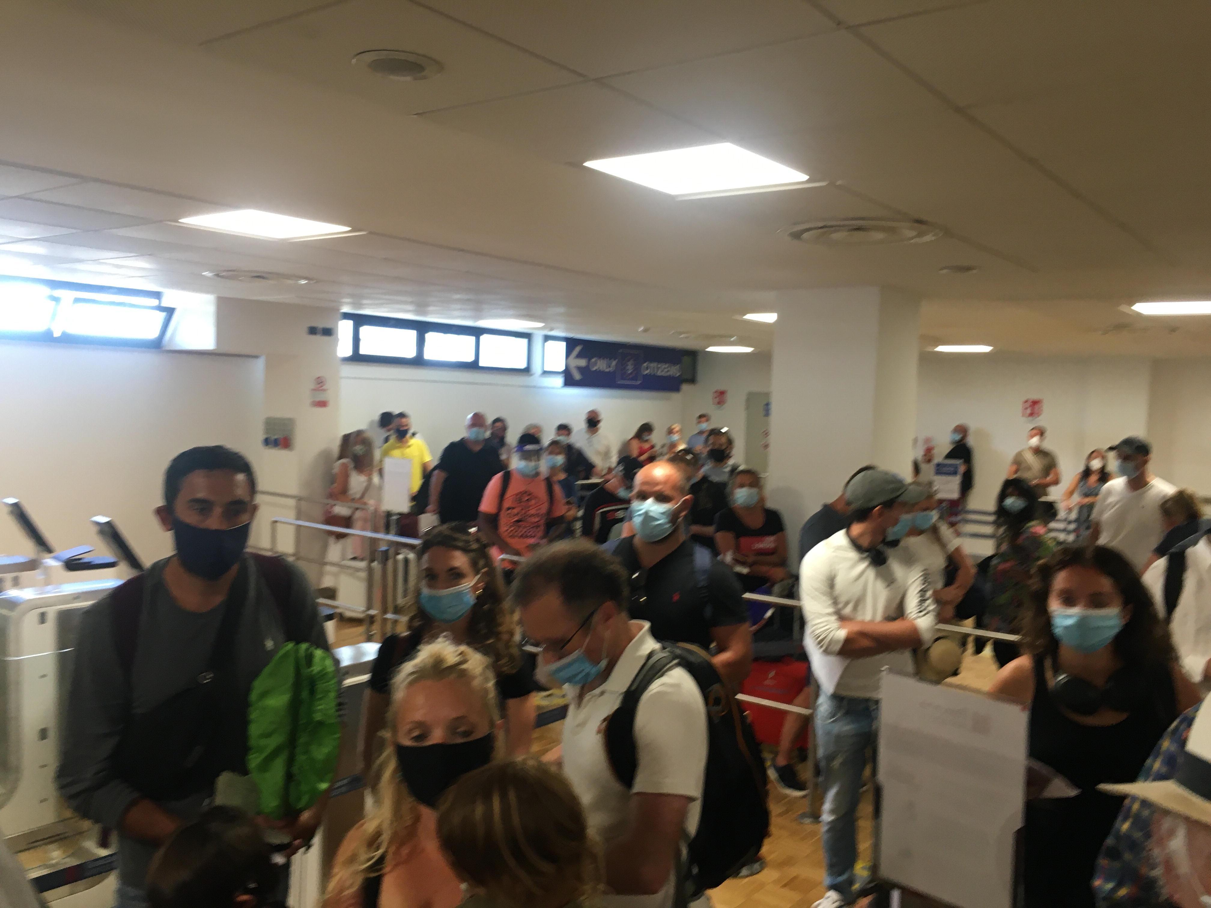 Pisa, in fila a distanza ravvicinata per far controllare i passaporti in aeroporto 