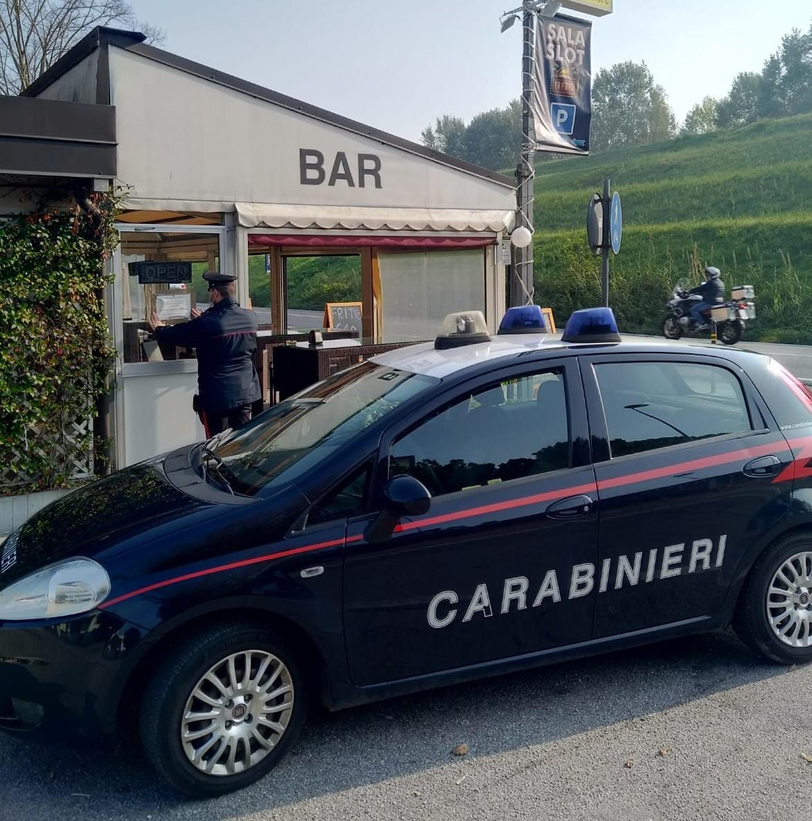 I carabinieri mentre appongono la notifica di chiusura per 10 giorni al bar Open Space di Argenta