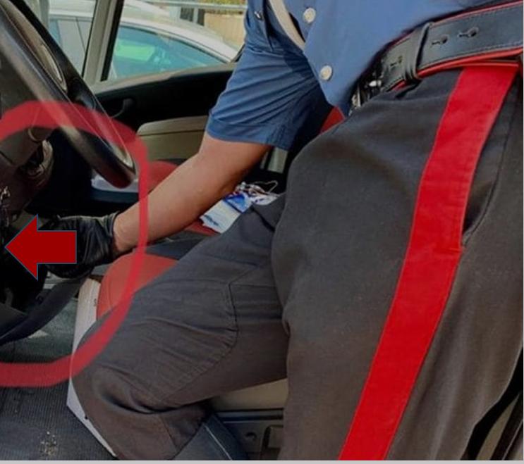 Un carabiniere mostra il vano creato appositamente nell'auto di uno degli arrestati per nascondere la droga