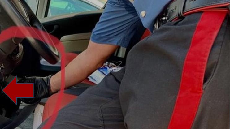 Un carabiniere mostra il vano creato appositamente nell'auto di uno degli arrestati per nascondere la droga