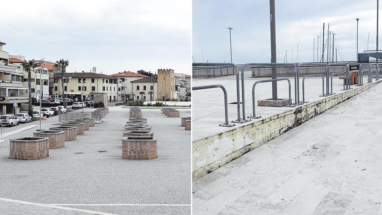 A sinistra le fioriere ormai vuote da anni in piazza Unità d’Italia e sullo sfondo la Torre di San Vincenzo; la pavimentazione in travertino e una rampa di accesso (foto Paolo Barlettani)