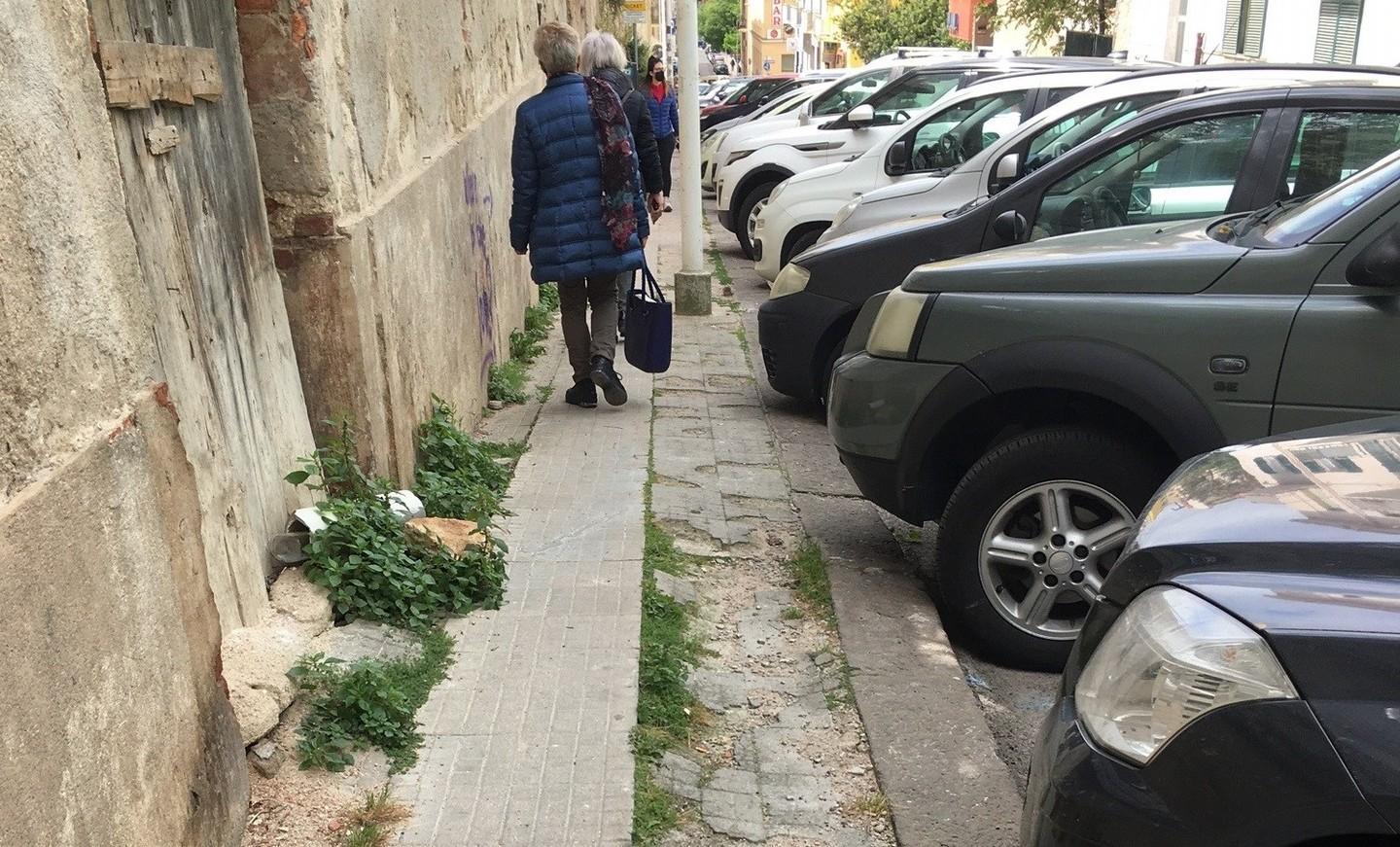 Pedoni in fila indiana sul marciapiede