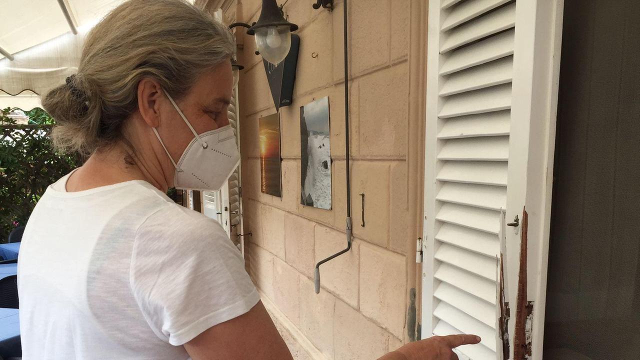 Sandra Turini indica la persiana forzata del suo albergo
