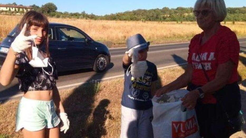 Nonna Laura insieme con i nipoti Lara e Marco raccoglie mascherine gettate a terra