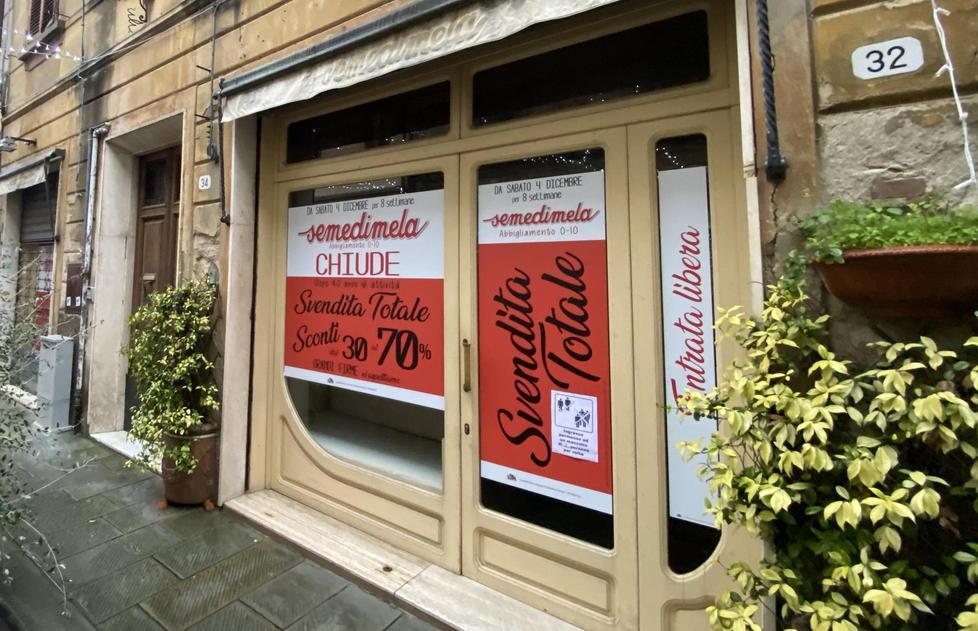 La vetrina di Semedimela con l’annuncio della svendita totale e della successiva chiusura dell’attività