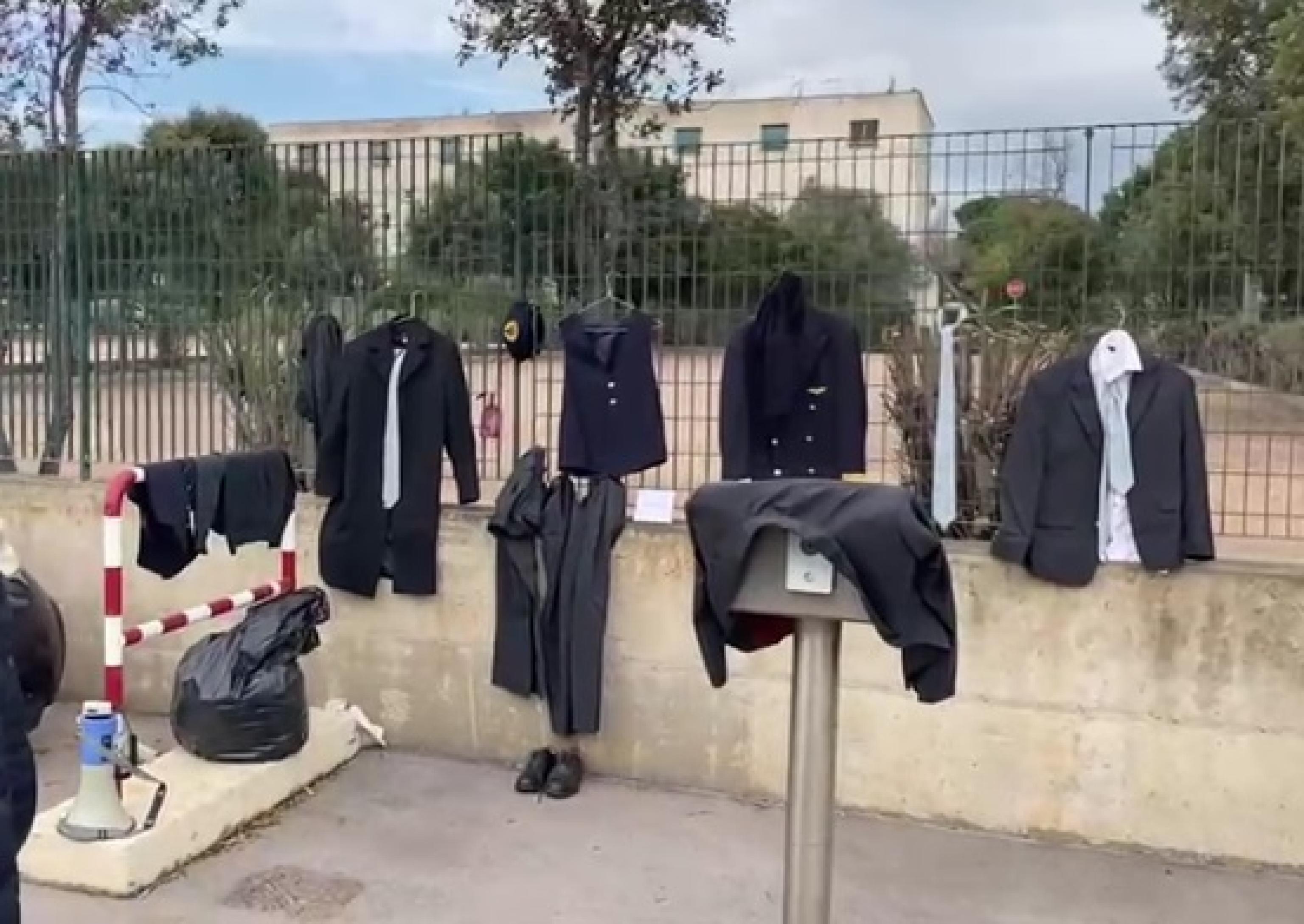 Le divise di Air Italy appese sulla recinzione dell'aeroporto (foto vanna sanna)