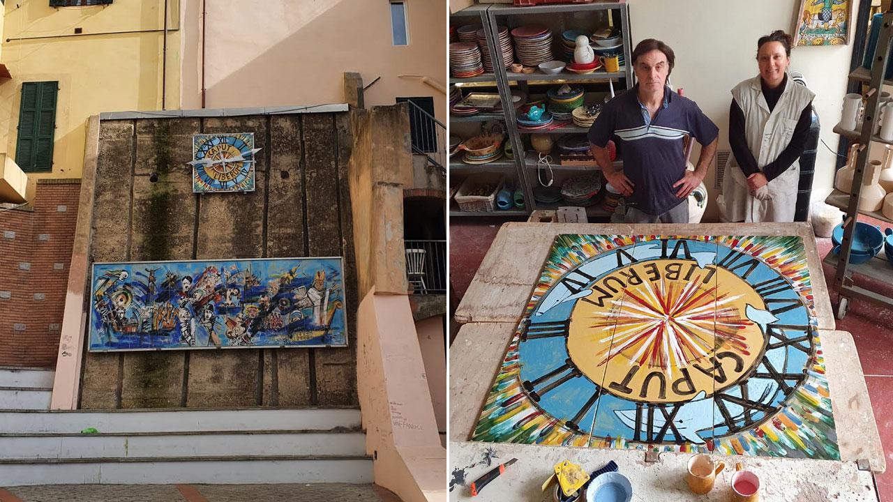 A sinistra il Millennium di Bolano di nuovo al suo posto in piazzetta la Vantina a Capoliveri. A destra la pittrice Roberta Paci e il titolare della ceramiche Tombelli